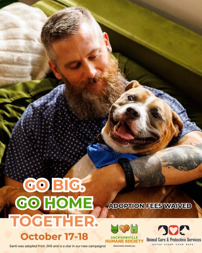 Man with beard and dog with blue bandana smiling, adoption event details.