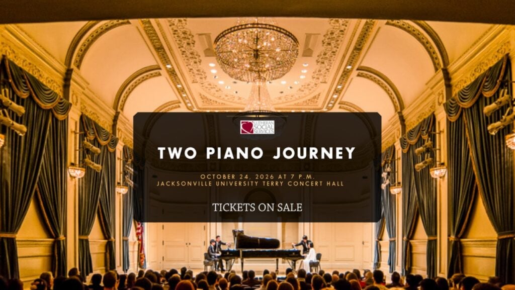 Two piano players perform on stage at Jacksonville University concert hall.