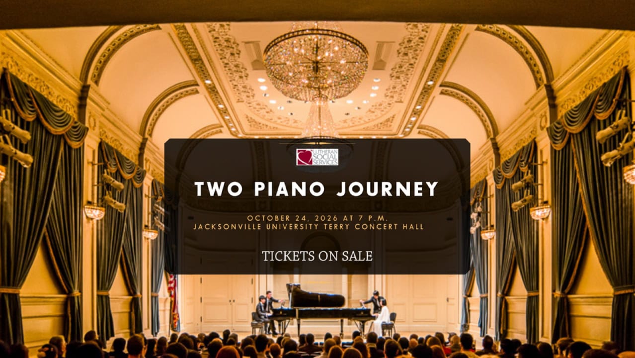 Two piano players perform on stage at Jacksonville University concert hall.